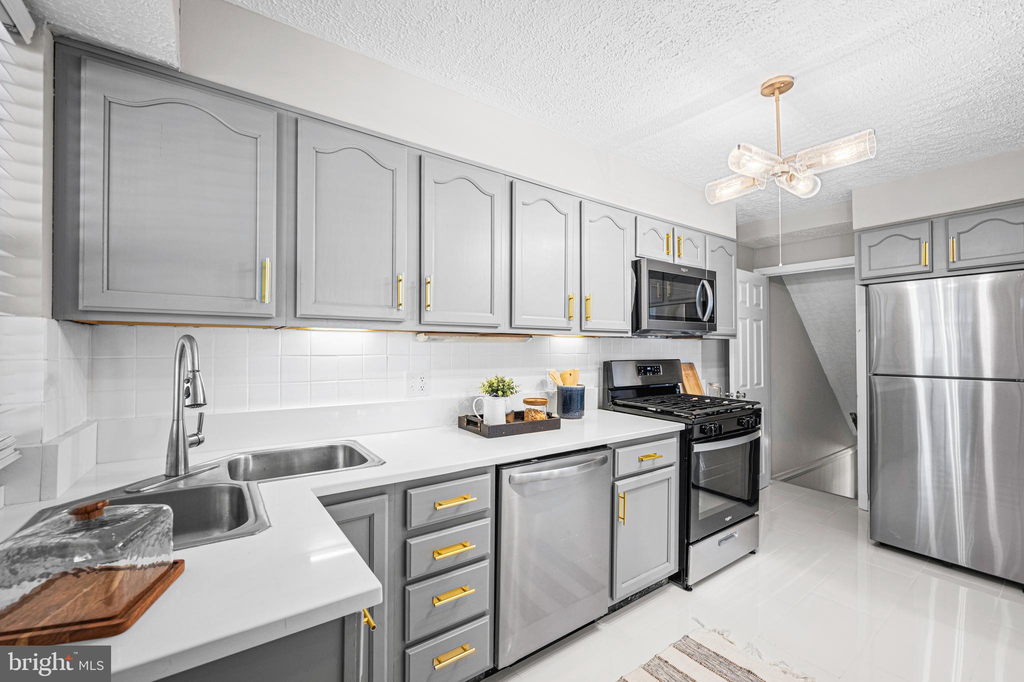 1935 Ramblewood Road Baltimore, MD 21239 - Photo 6 of 37 a kitchen with stainless steel appliances granite countertop a sink stove and refrigerator