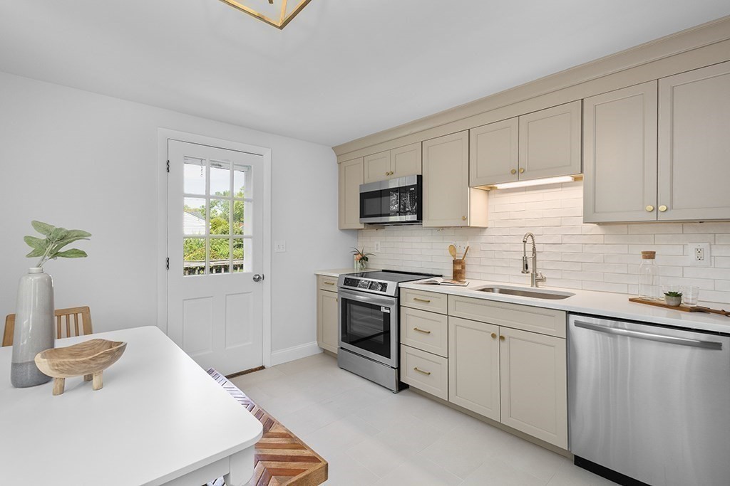 117 Oak Ridge Drive Ayer, MA 01432 - Photo 8 of 26 a kitchen with a sink stove and microwave