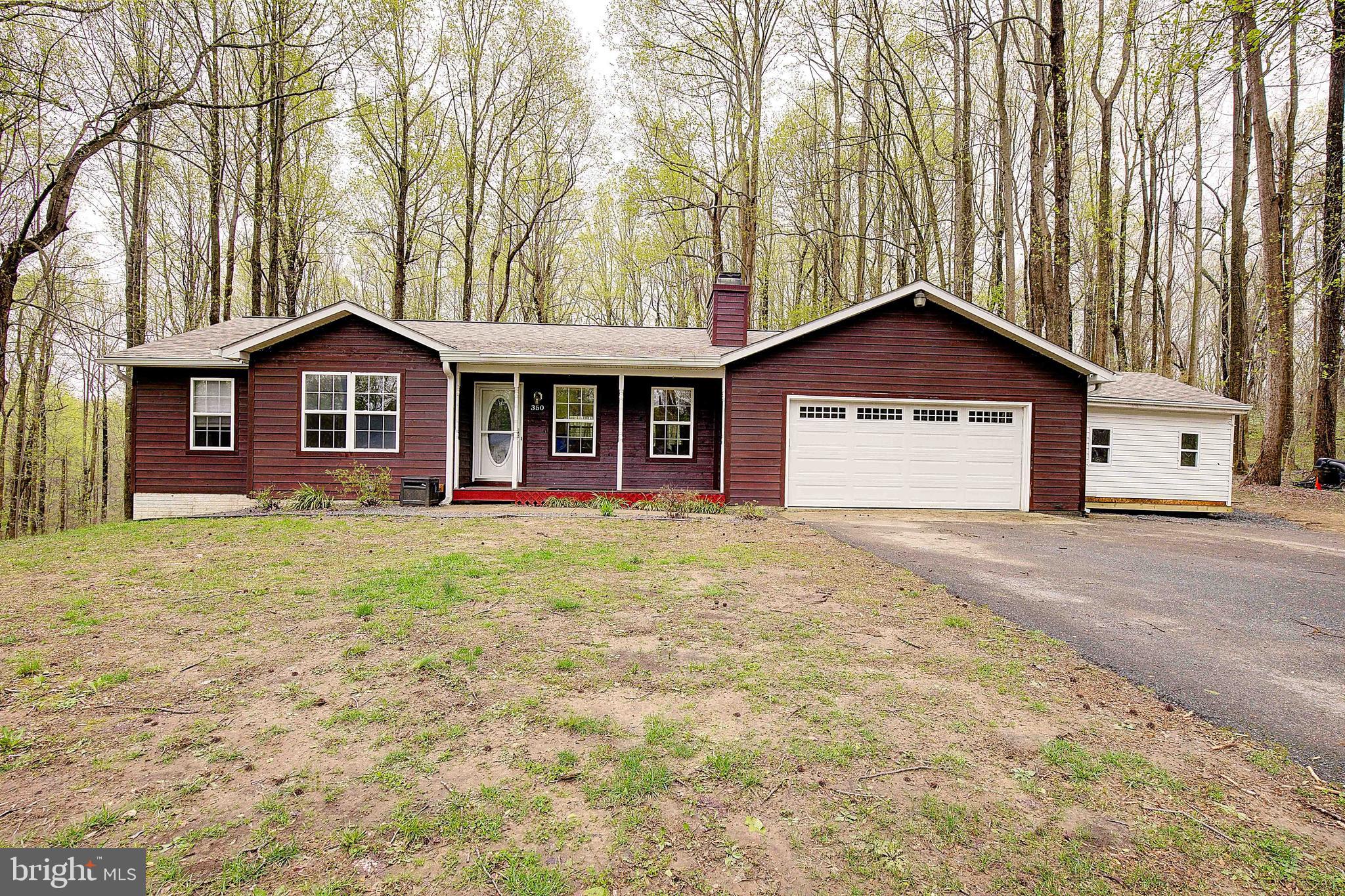 350 South Shore Drive, Unit 1 Prince Frederick, MD 20678 - Photo 1 of 53 a front view of a house with a yard and garage