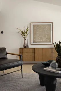 a living room with furniture flowerpot and a potted plant