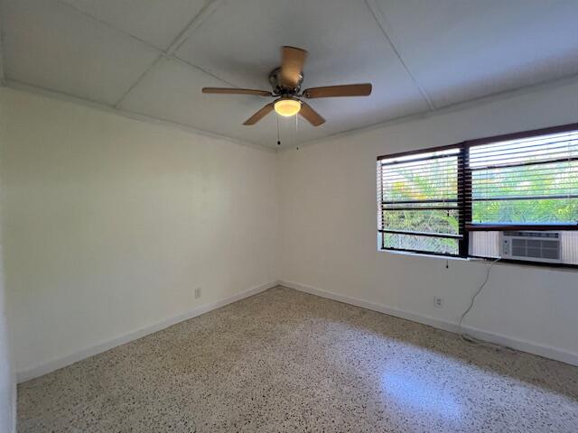311 Inlet Way, Unit 10 Palm Beach Shores, FL 33404 - Photo 14 of 18 an empty room with windows and ceiling fan