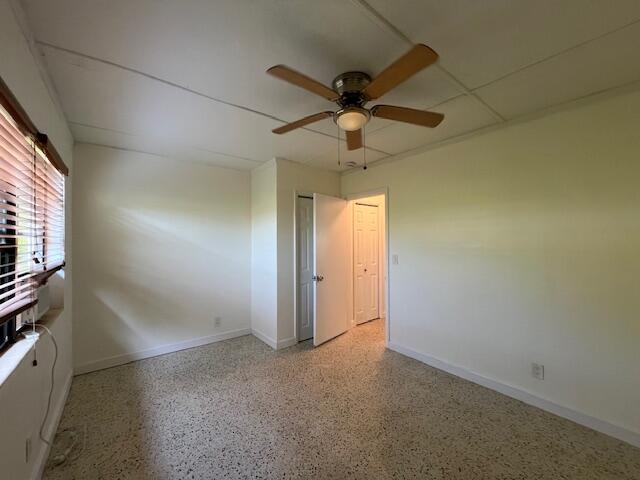 311 Inlet Way, Unit 10 Palm Beach Shores, FL 33404 - Photo 17 of 18 an empty room with a ceiling fan and a window