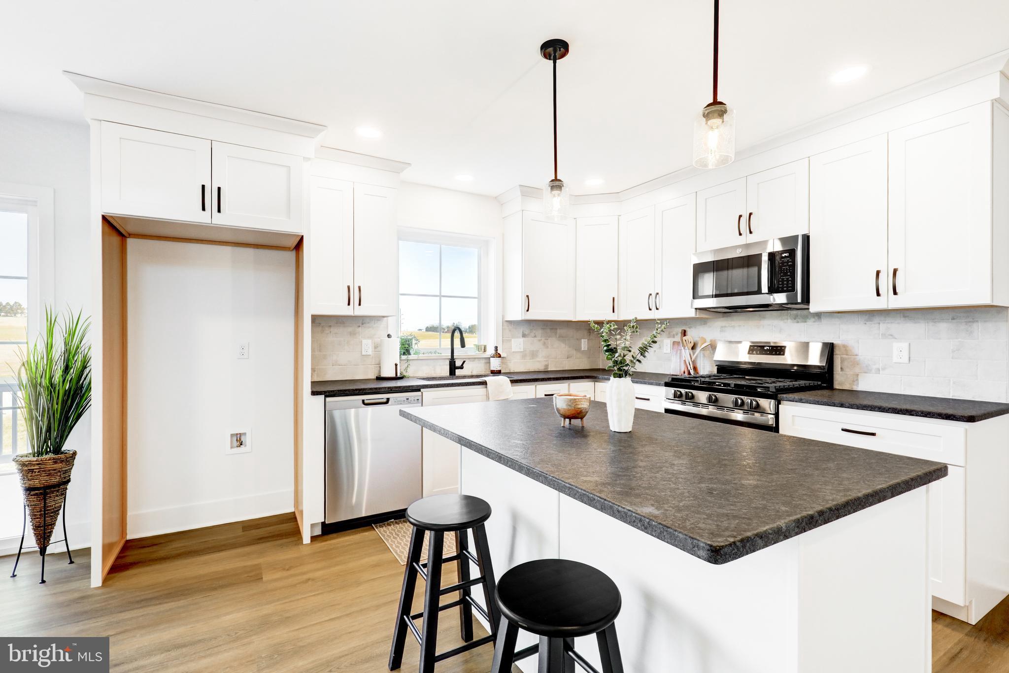 223 Coffee Goss Road Marietta, PA 17547 - Photo 8 of 19 a kitchen with stainless steel appliances granite countertop a sink a stove a refrigerator and island with wooden floor
