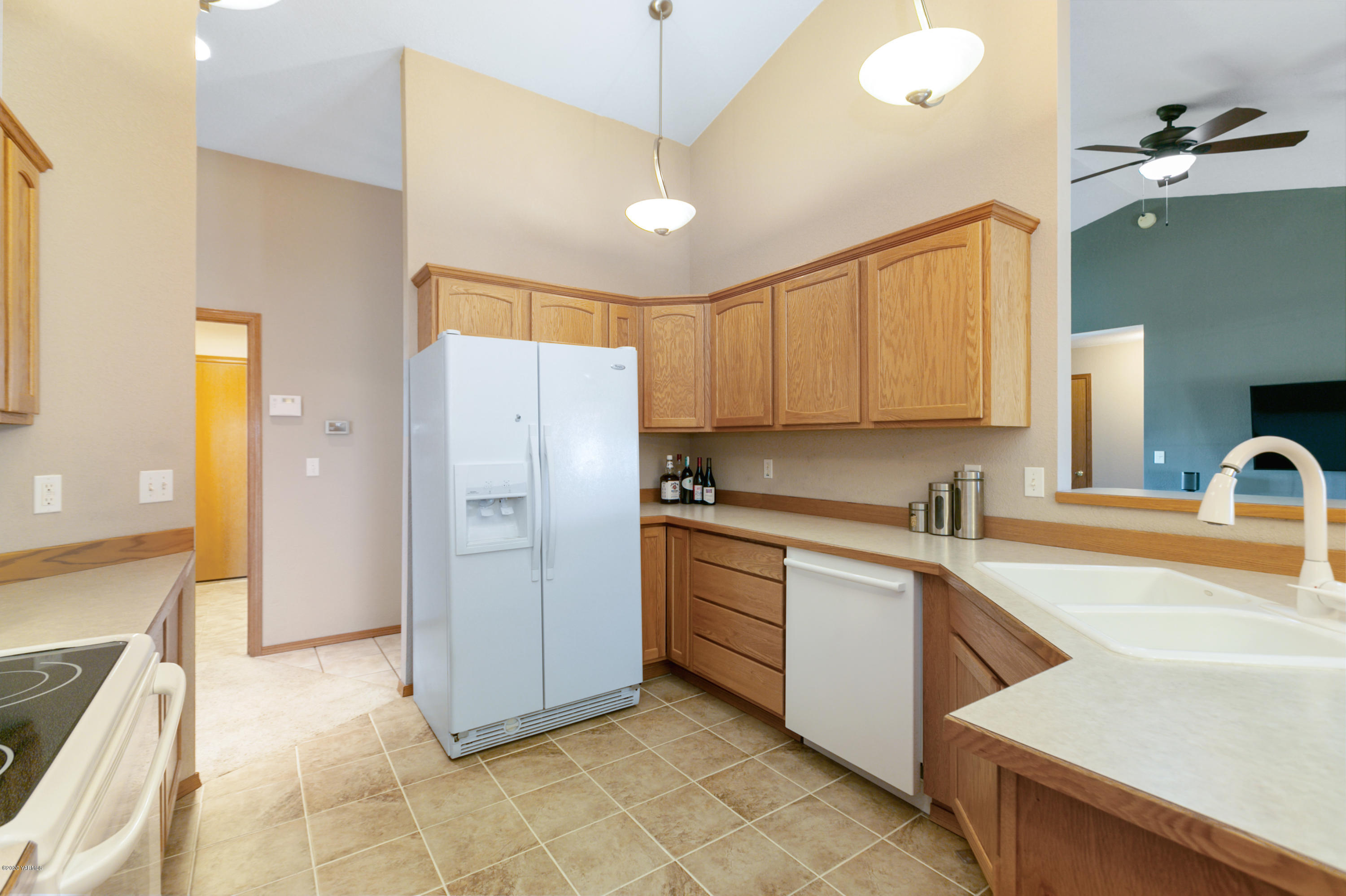 681 Red Tail Road Yakima, WA 98908 - Photo 12 of 21 a kitchen with a sink a refrigerator and a stove