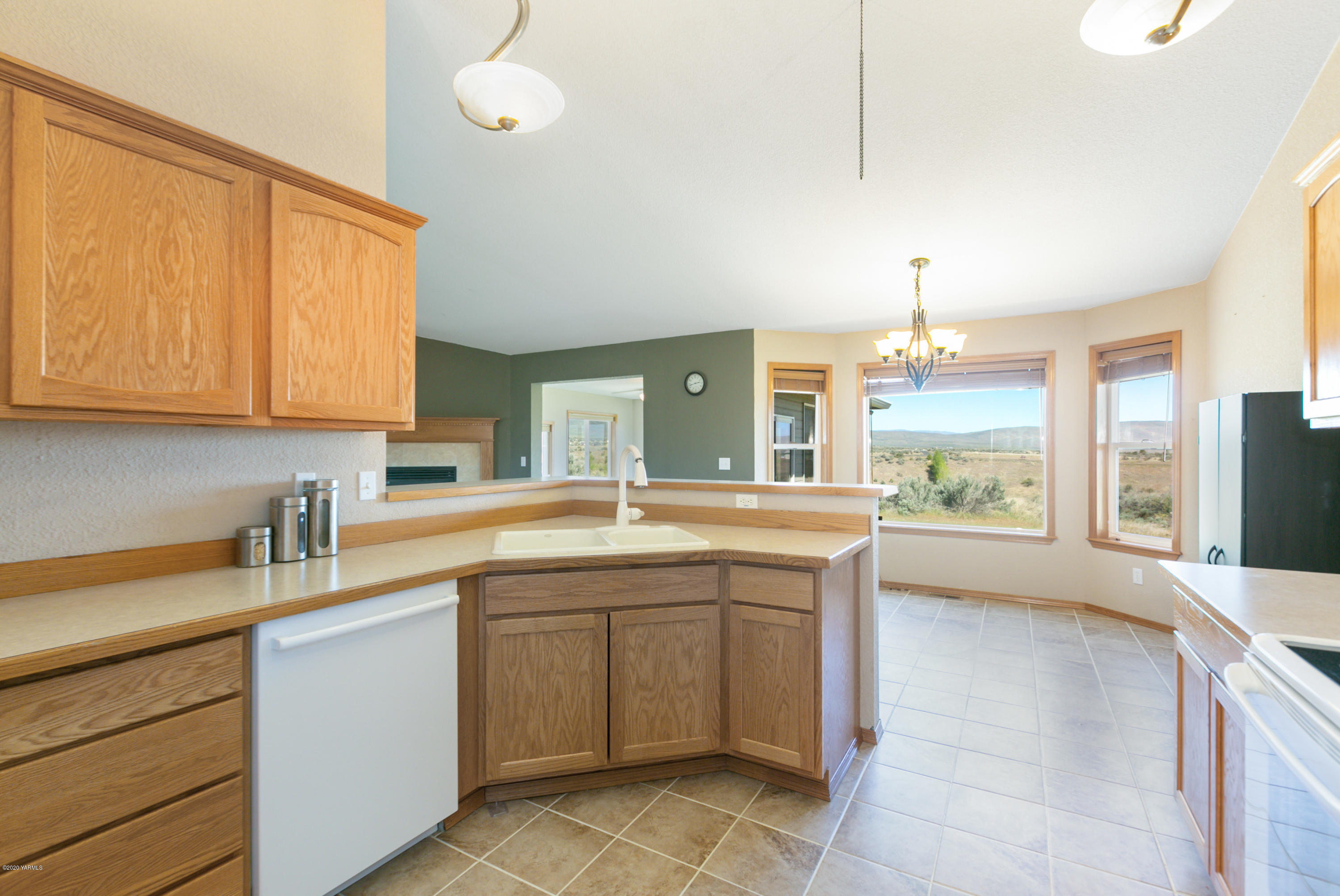 681 Red Tail Road Yakima, WA 98908 - Photo 13 of 21 a kitchen with a sink stove and cabinets