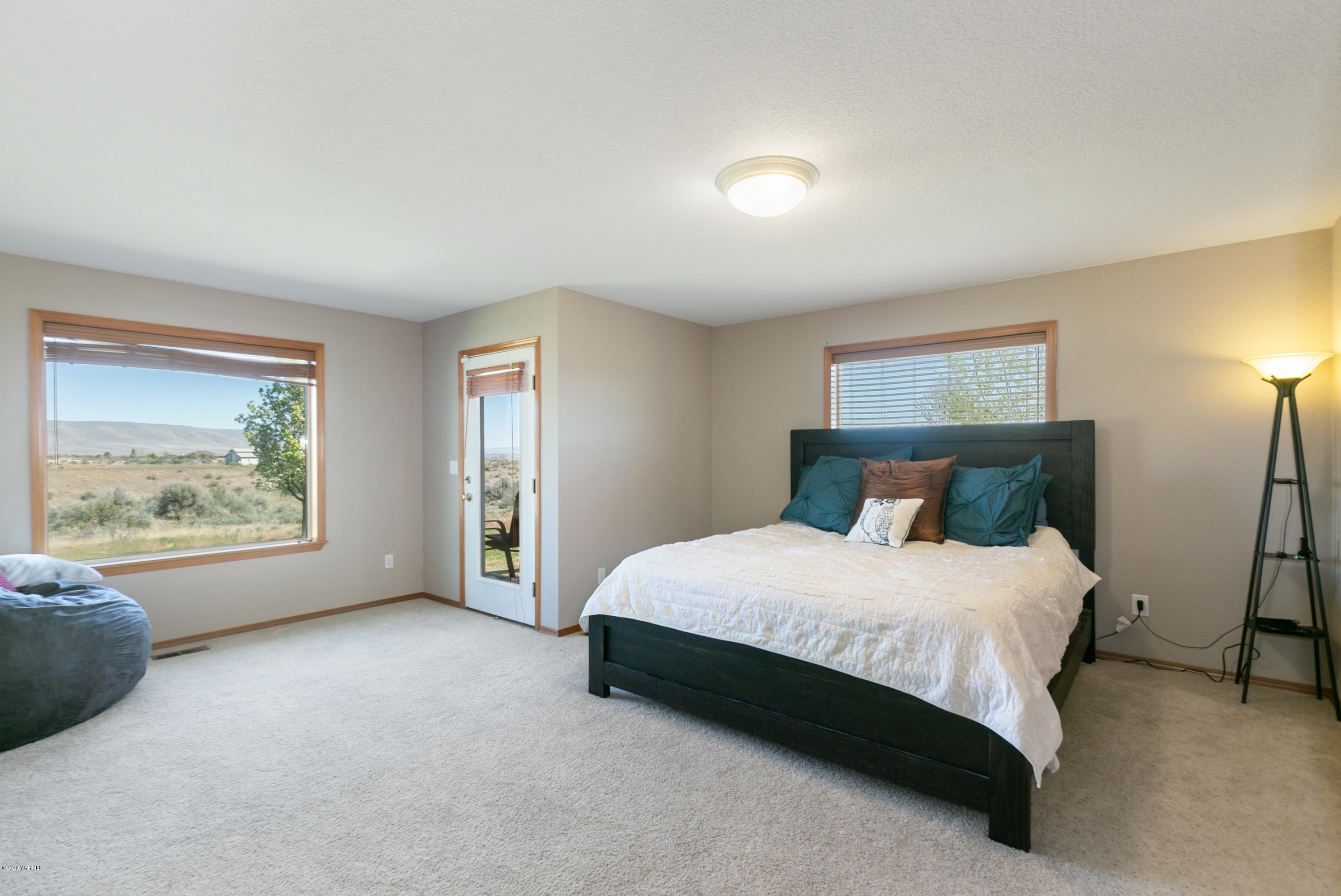 681 Red Tail Road Yakima, WA 98908 - Photo 16 of 21 a spacious bedroom with a bed and a couch