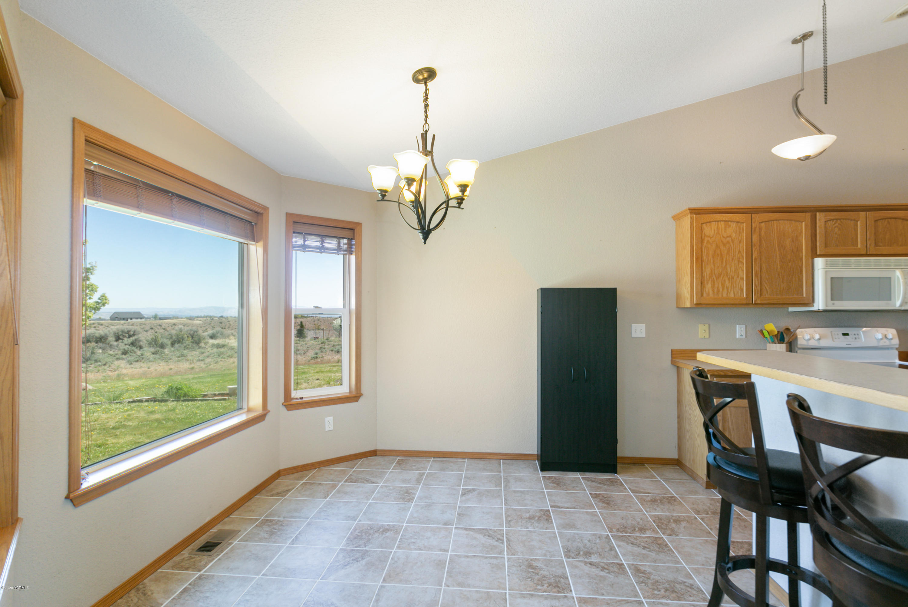 681 Red Tail Road Yakima, WA 98908 - Photo 10 of 21 a view of a dining room with furniture and a chandelier