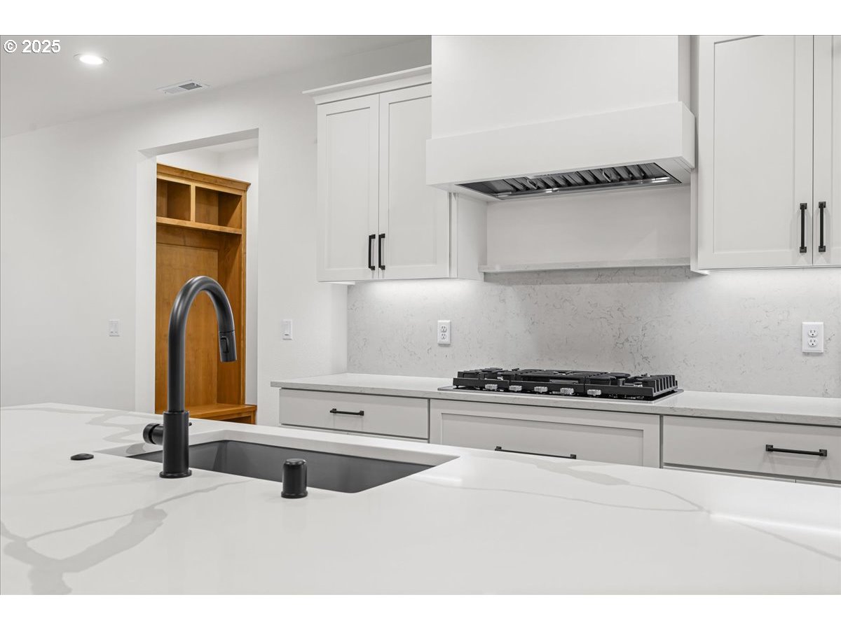 3518 North 11th Circle Ridgefield, WA 98642 - Photo 13 of 44 a kitchen with a sink a stove and cabinets