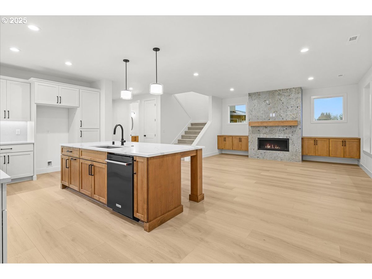 3518 North 11th Circle Ridgefield, WA 98642 - Photo 16 of 44 a large kitchen with stainless steel appliances granite countertop a stove a sink and a wooden floors