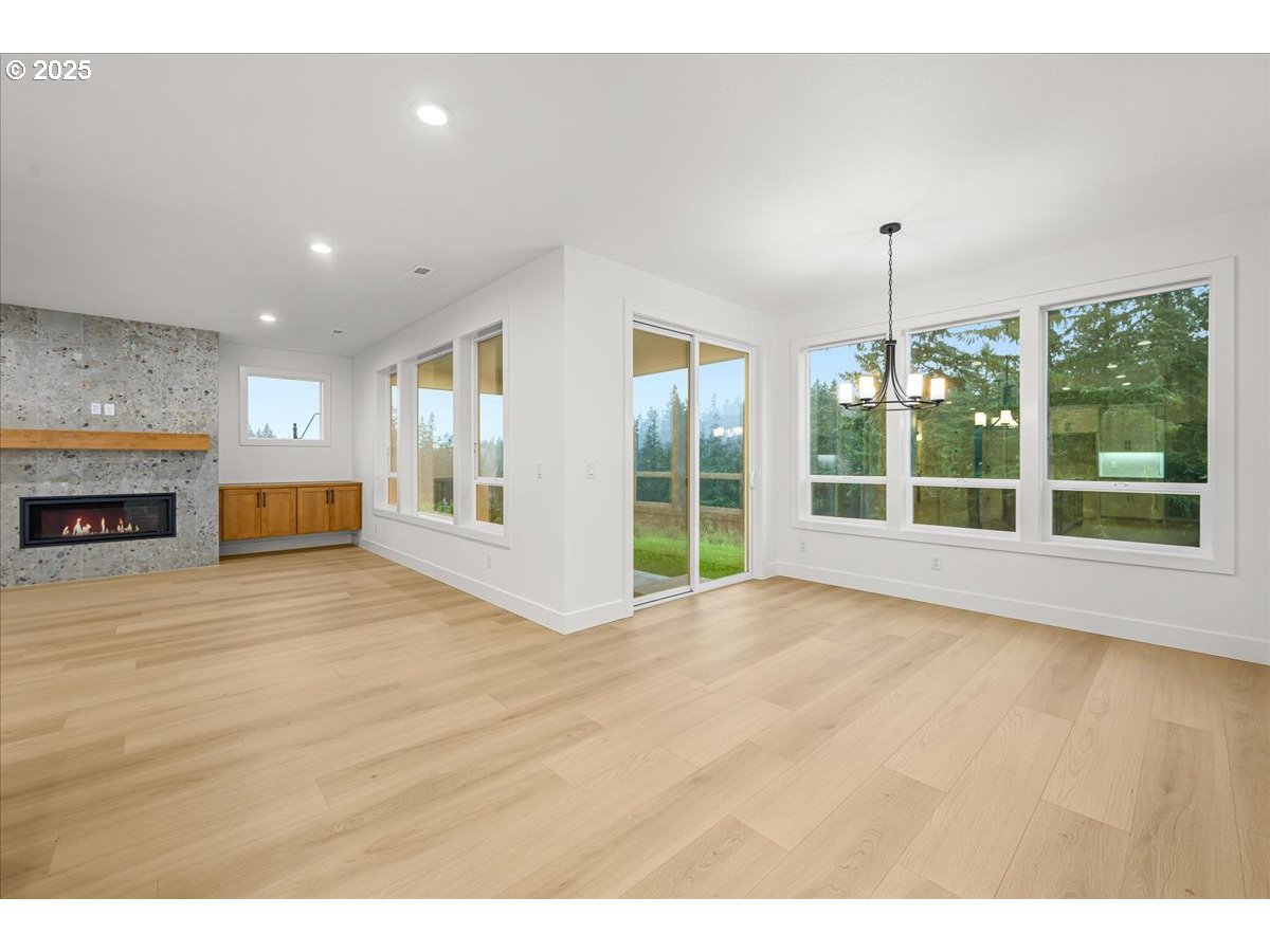 3518 North 11th Circle Ridgefield, WA 98642 - Photo 18 of 44 a view of an empty room with a fireplace and a window