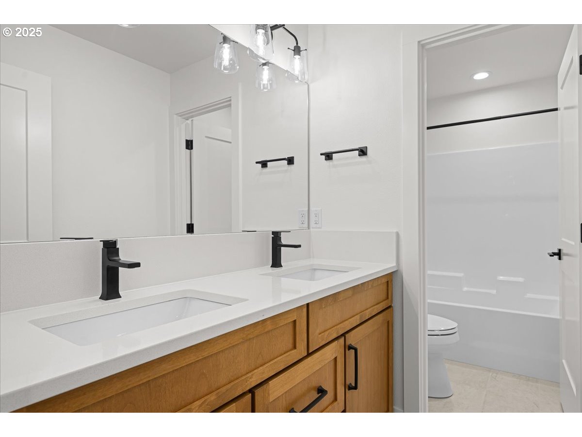 3518 North 11th Circle Ridgefield, WA 98642 - Photo 34 of 44 a bathroom with a sink and a mirror