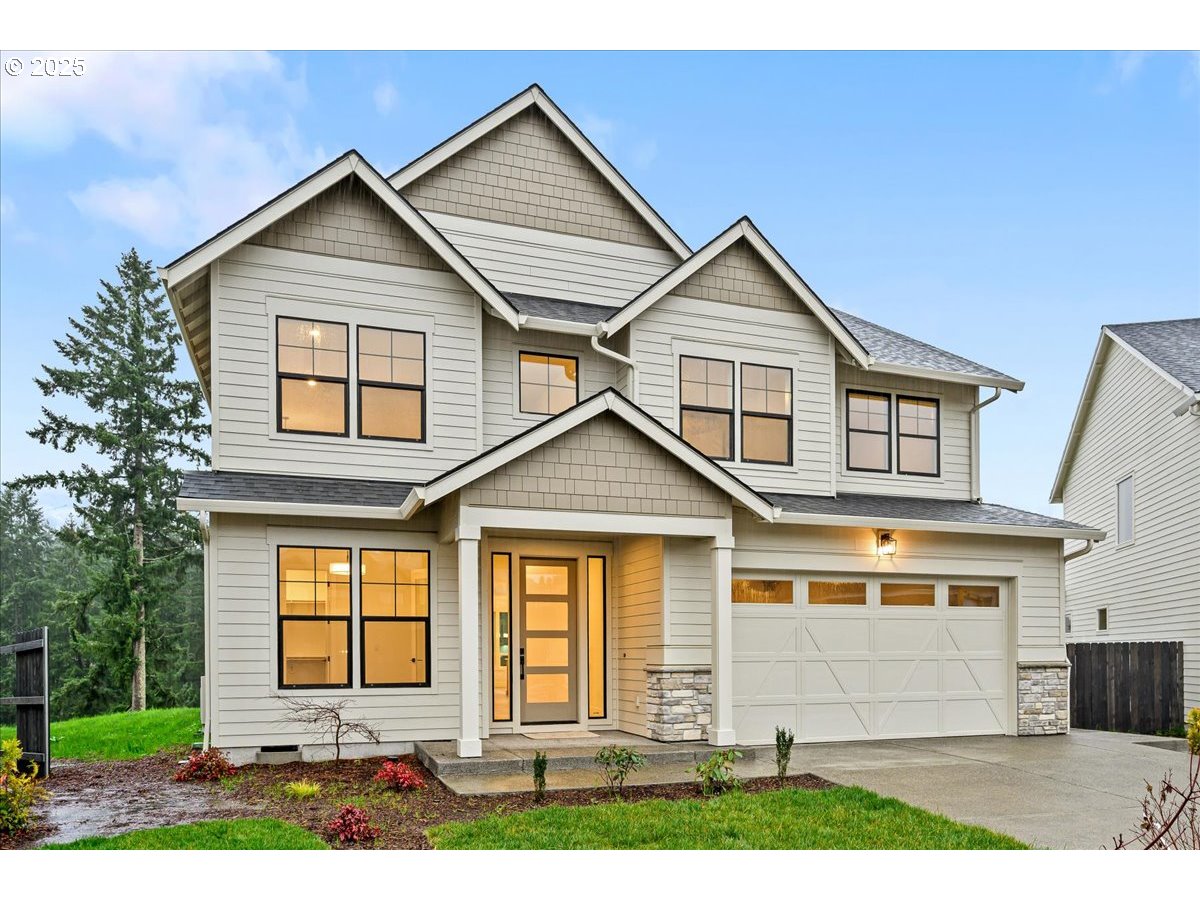 3518 North 11th Circle Ridgefield, WA 98642 - Photo 44 of 44 a front view of a house with a yard and garage