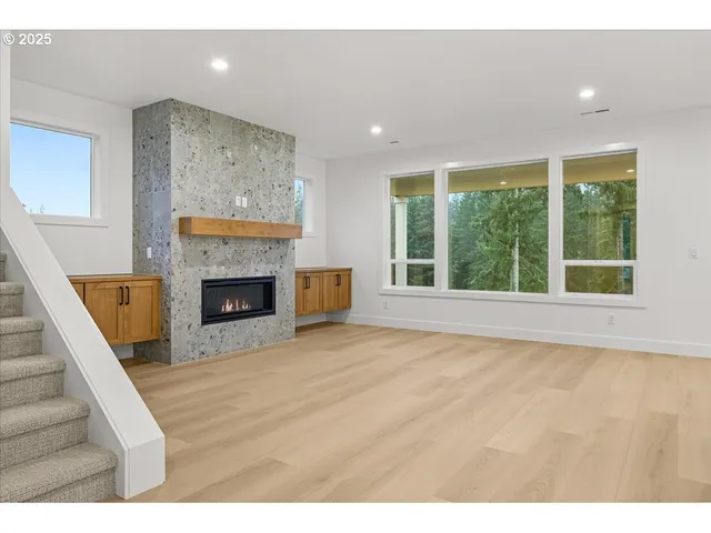 a view of empty room with fireplace and fan