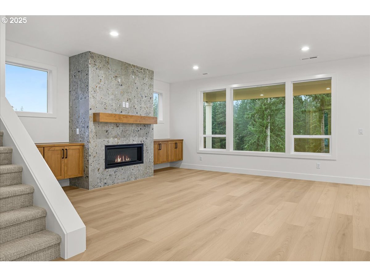 3518 North 11th Circle Ridgefield, WA 98642 - Photo 5 of 44 a view of empty room with fireplace and fan
