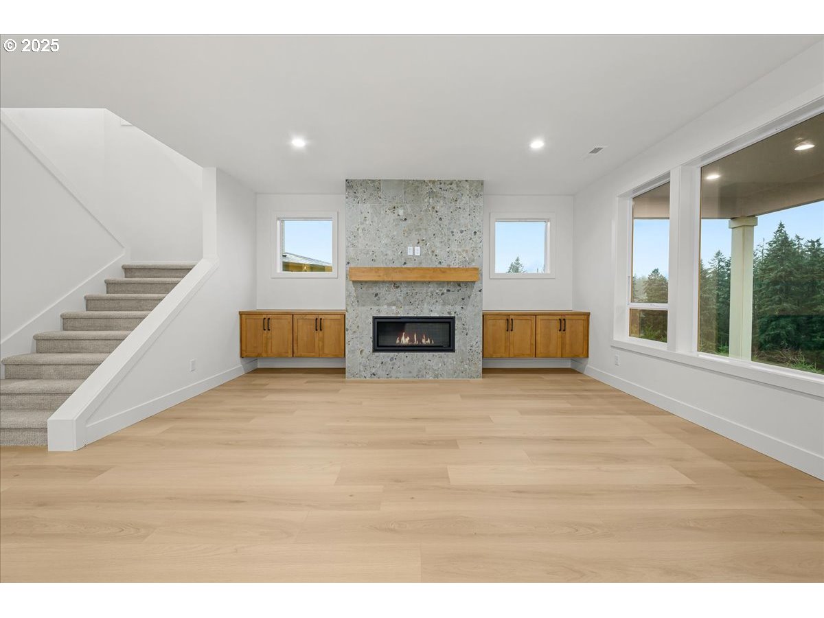 3518 North 11th Circle Ridgefield, WA 98642 - Photo 7 of 44 a view of empty room with wooden floor and fireplace