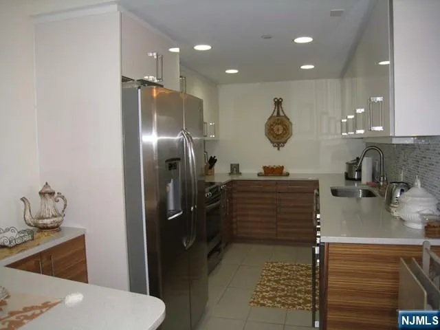 a room with a refrigerator and cabinets