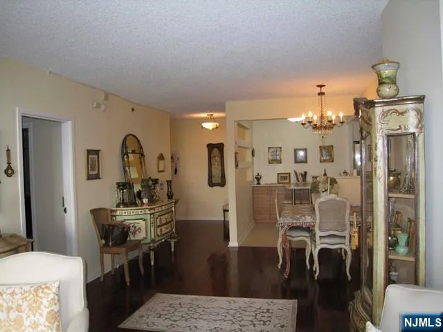 a view of a dining room with furniture and chandelier