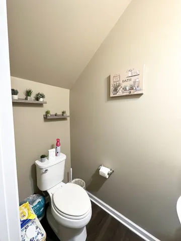 a white toilet sitting next to a bathroom sink