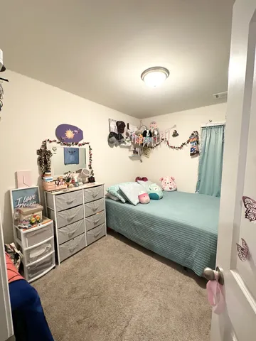 a bedroom with a bed and a dresser