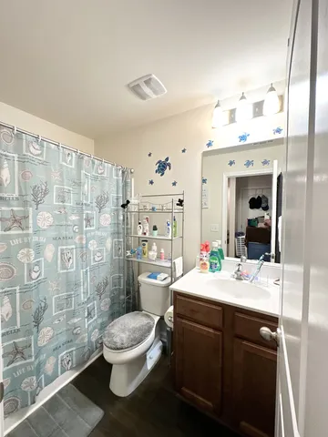 a bathroom with a sink mirror toilet and shower