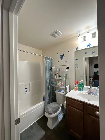 a bathroom with a sink toilet tub and shower