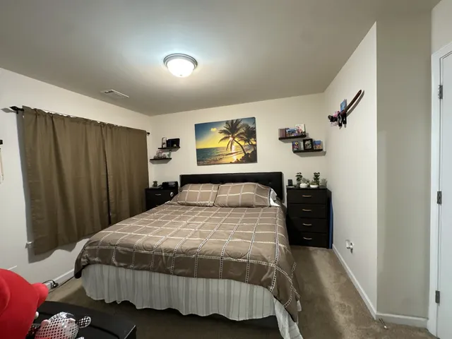 a bedroom with a bed and a dresser