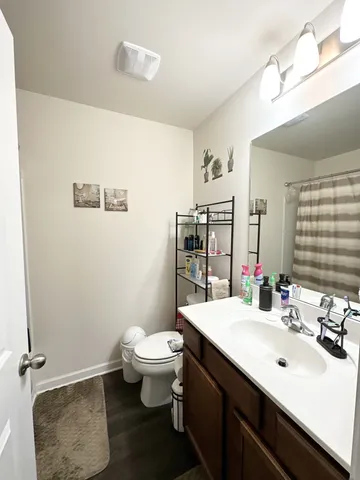 a bathroom with a sink toilet and mirror