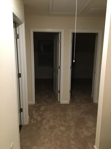 a view of a hallway to rooms