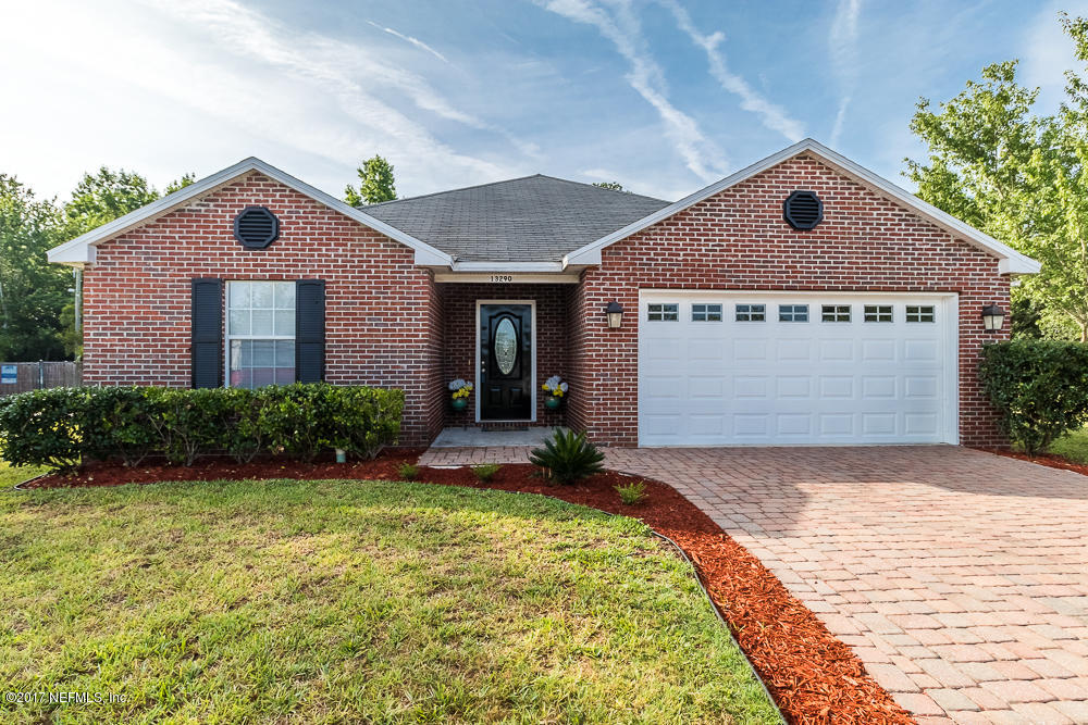13290 Pacemaker Drive Jacksonville, FL 32225 - Photo 1 of 40 a front view of a house with a yard and garage