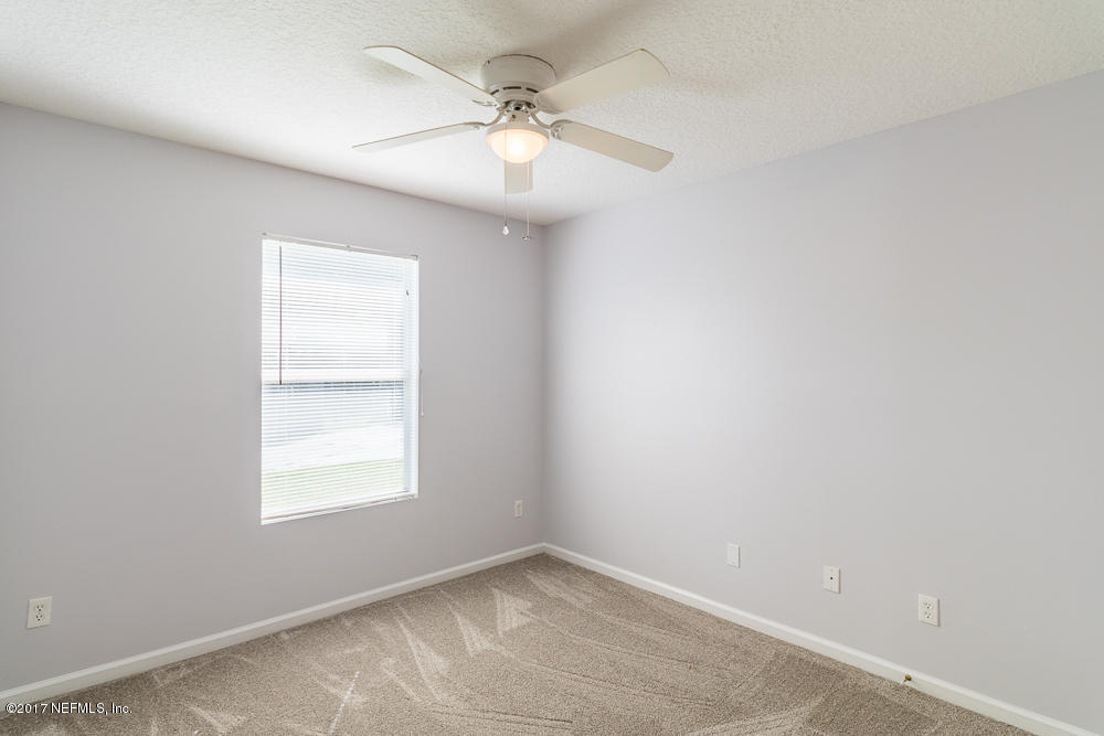 13290 Pacemaker Drive Jacksonville, FL 32225 - Photo 25 of 40 an empty room with windows and fan