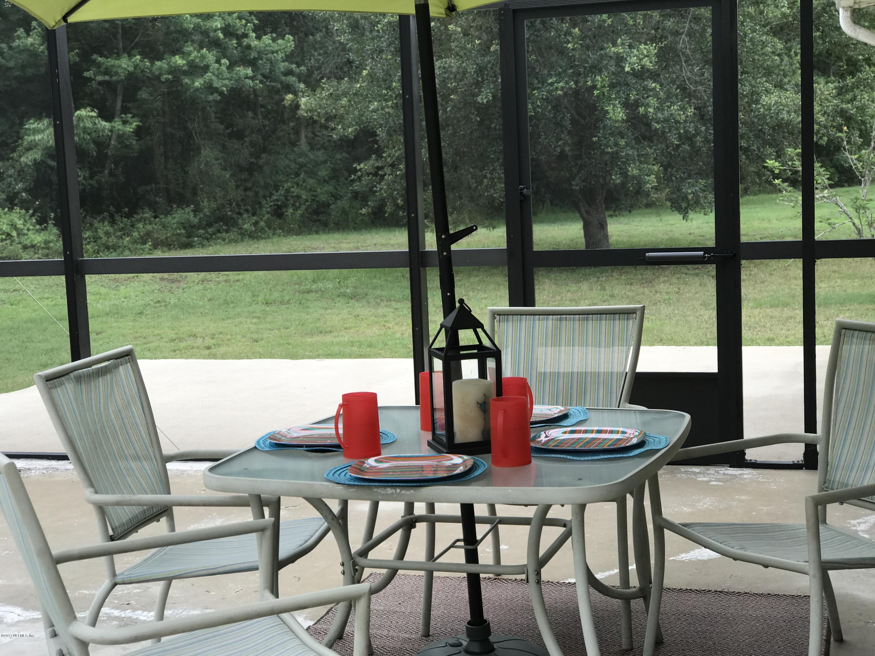 13290 Pacemaker Drive Jacksonville, FL 32225 - Photo 3 of 40 a outdoor dining space with furniture and outdoor view