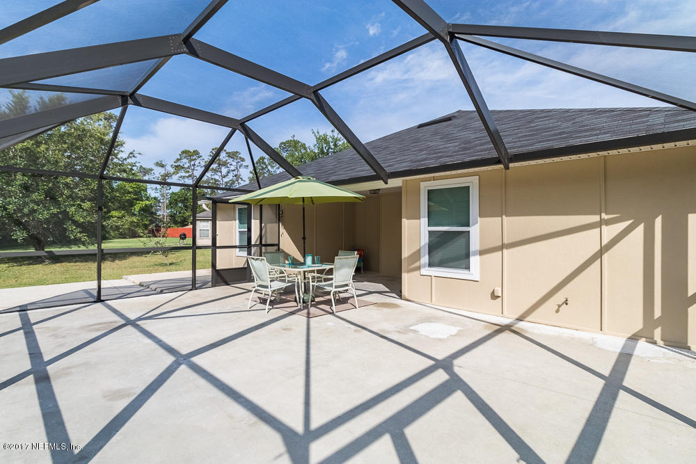 13290 Pacemaker Drive Jacksonville, FL 32225 - Photo 31 of 40 a view of a patio with a table and chairs