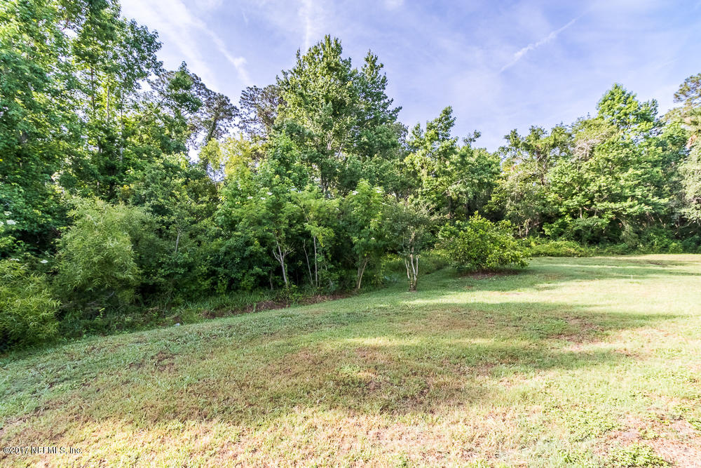 13290 Pacemaker Drive Jacksonville, FL 32225 - Photo 4 of 40 a view of a field with a tree