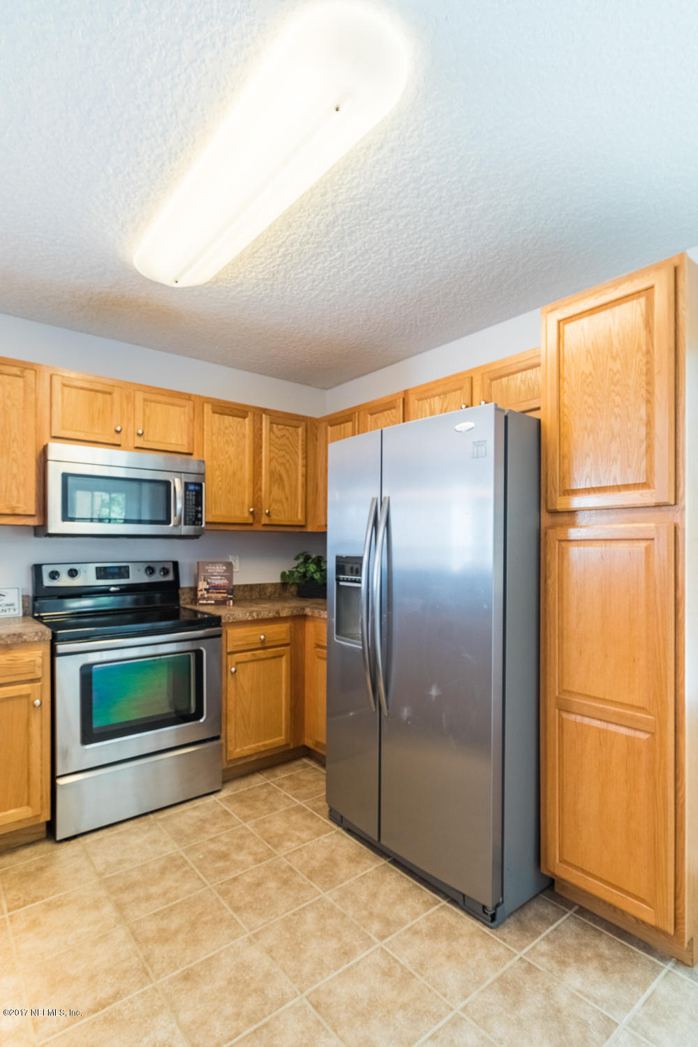 13290 Pacemaker Drive Jacksonville, FL 32225 - Photo 9 of 40 a kitchen with stainless steel appliances granite countertop a refrigerator and a stove top oven