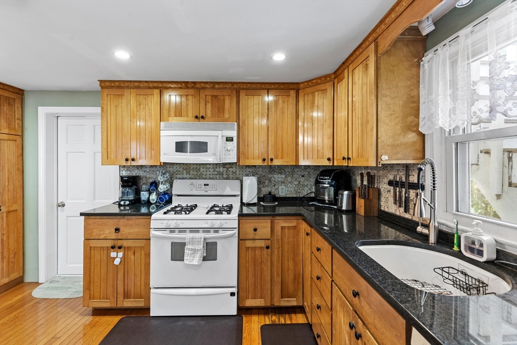 81 Everett Street Everett, MA 02149 - Photo 19 of 37 a kitchen with stainless steel appliances granite countertop a stove a sink and a microwave