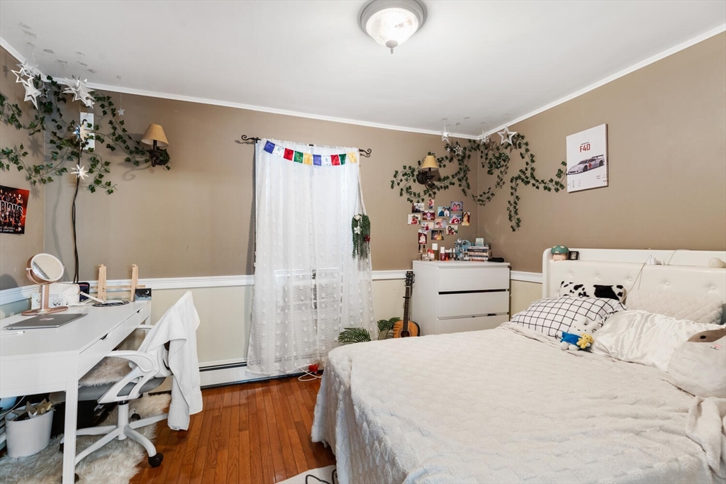 81 Everett Street Everett, MA 02149 - Photo 21 of 37 a bedroom with a bed and a table in it