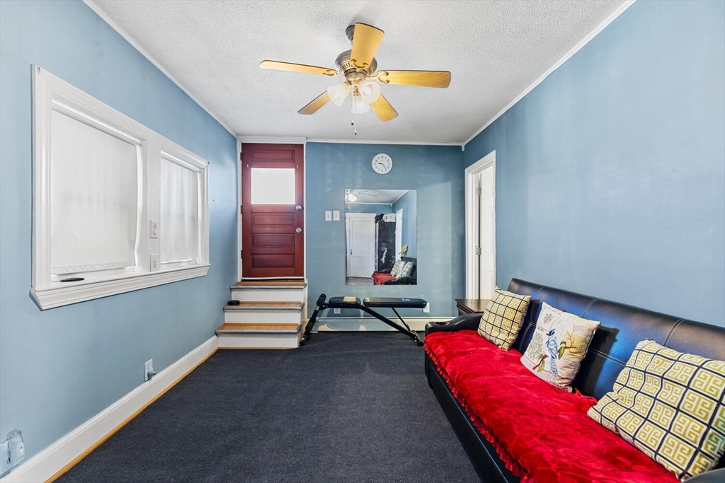 81 Everett Street Everett, MA 02149 - Photo 26 of 37 a living room with furniture and a chandelier