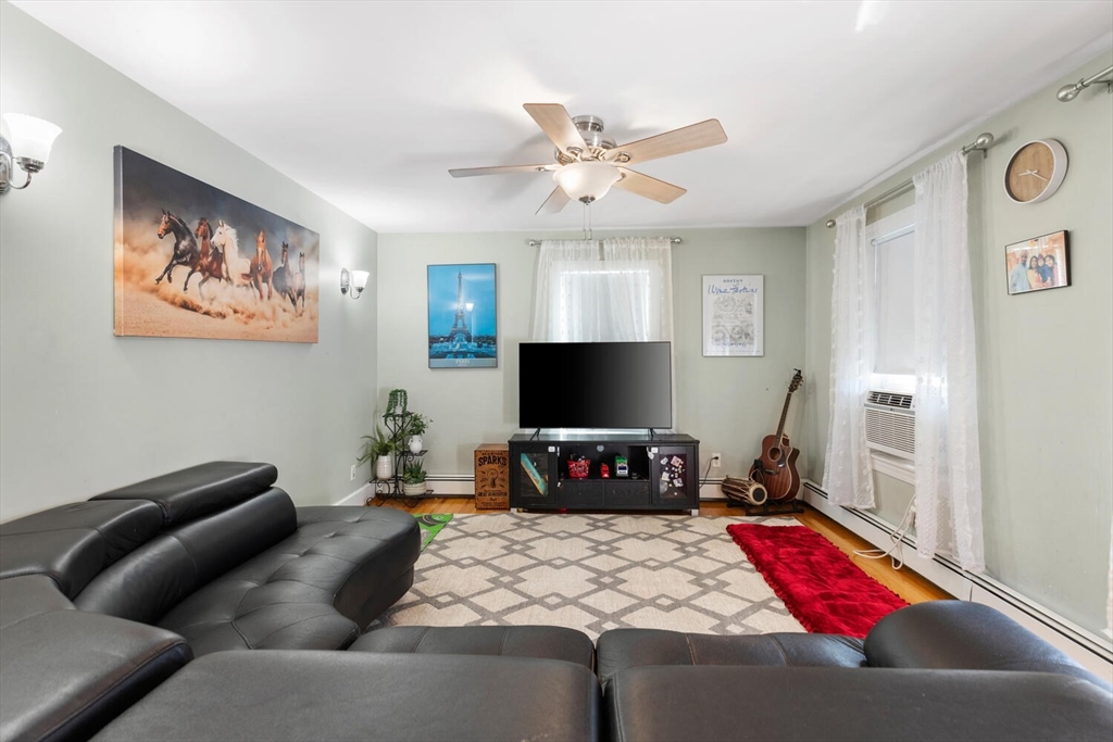 81 Everett Street Everett, MA 02149 - Photo 9 of 37 a living room with furniture and a flat screen tv