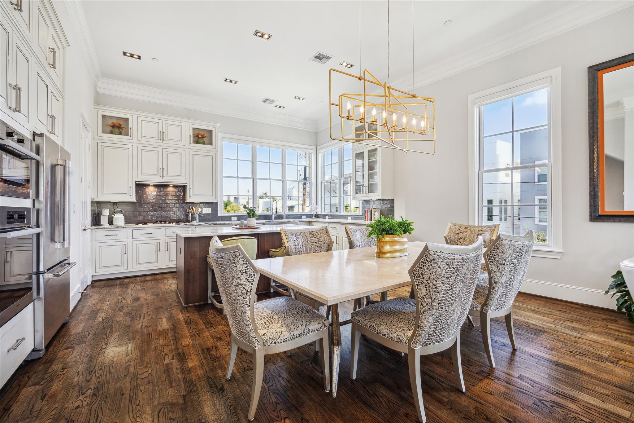 1619 Calumet Street Houston, TX 77004 - Photo 13 of 26 a dining room with stainless steel appliances kitchen island granite countertop a table chairs and a refrigerator