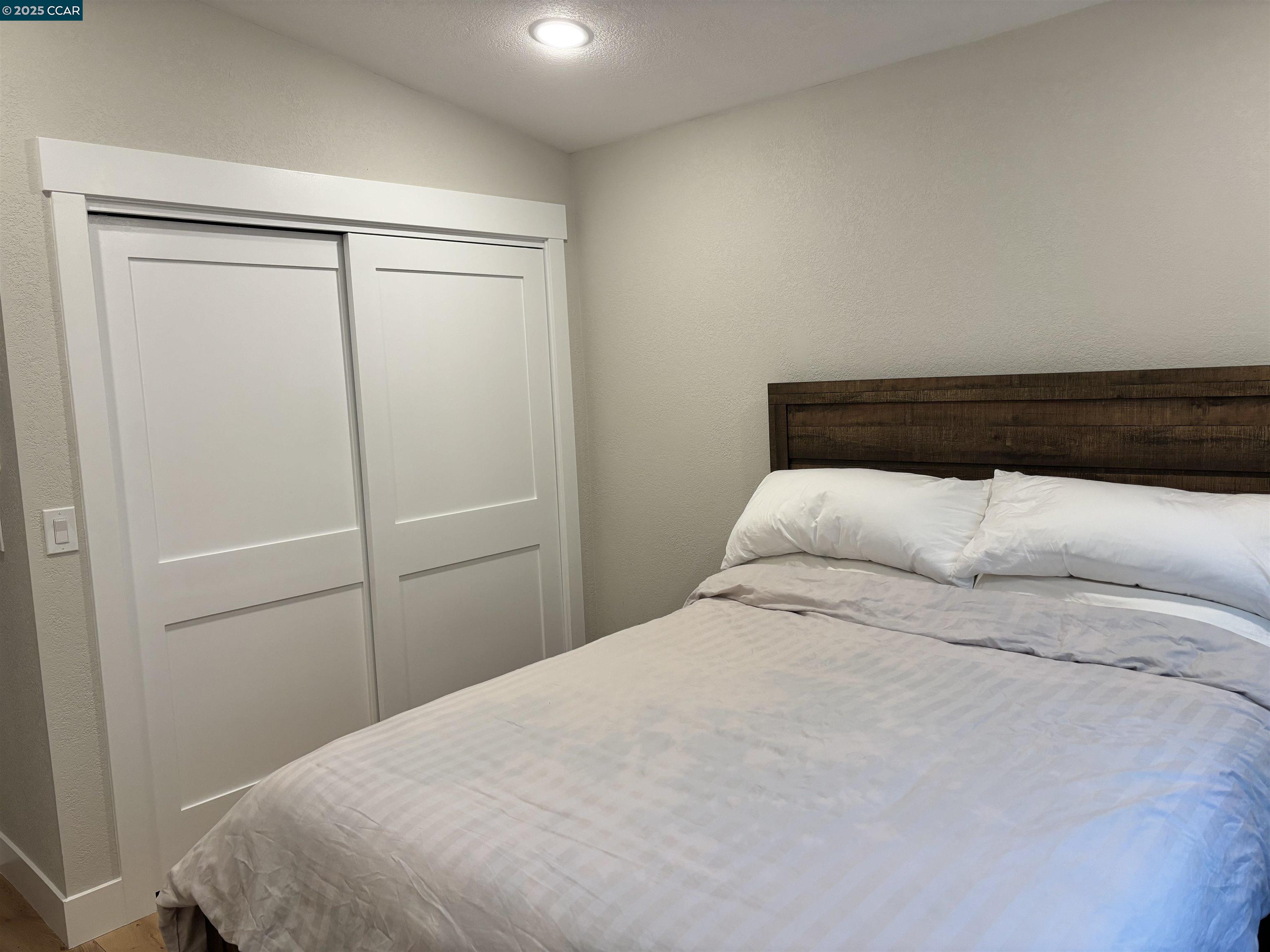 Tice Valley Walnut Creek, CA 94595 - Photo 13 of 17 a bedroom with a bed and a shower