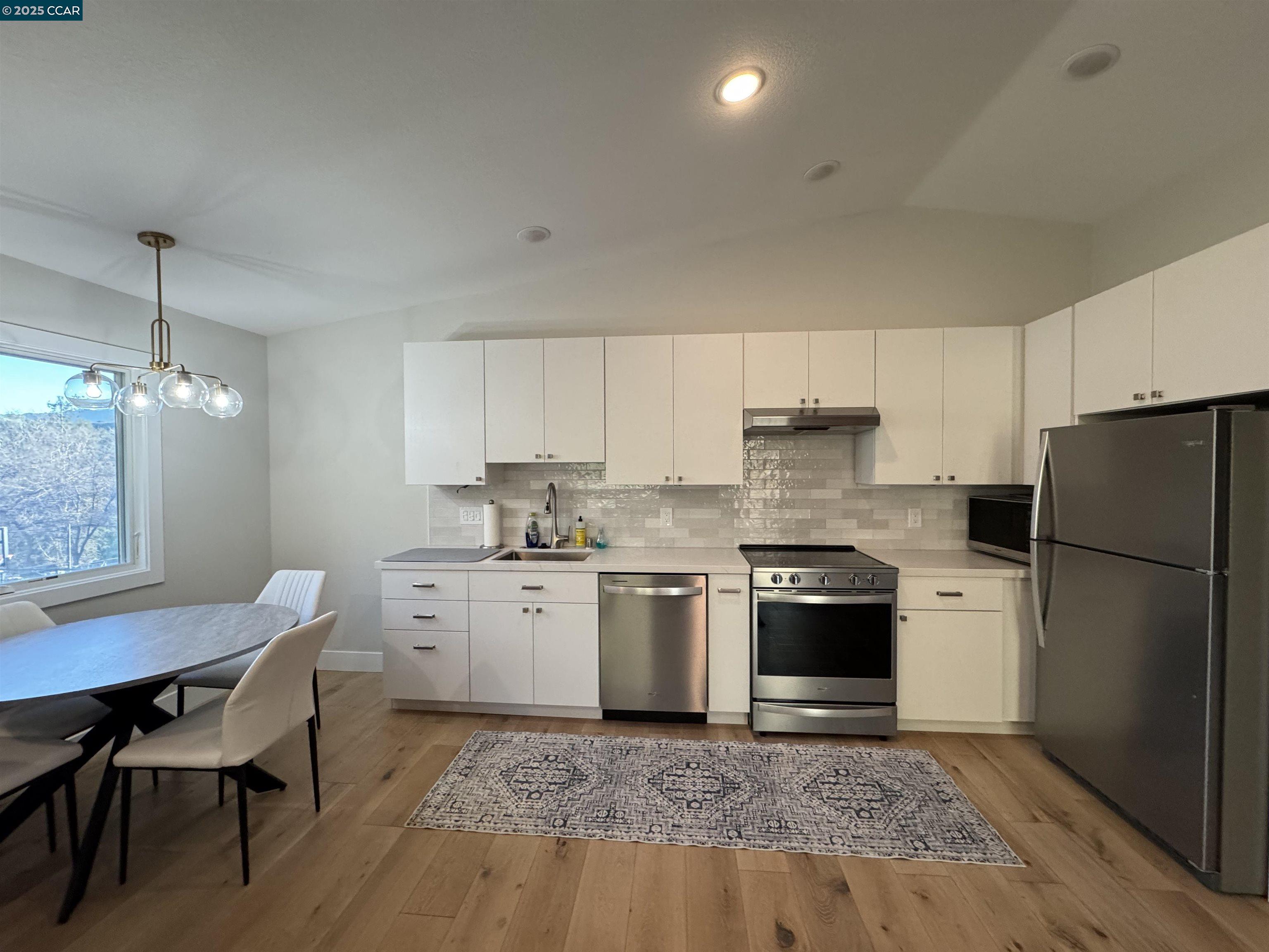 Tice Valley Walnut Creek, CA 94595 - Photo 8 of 17 a kitchen with a stove a sink and a refrigerator
