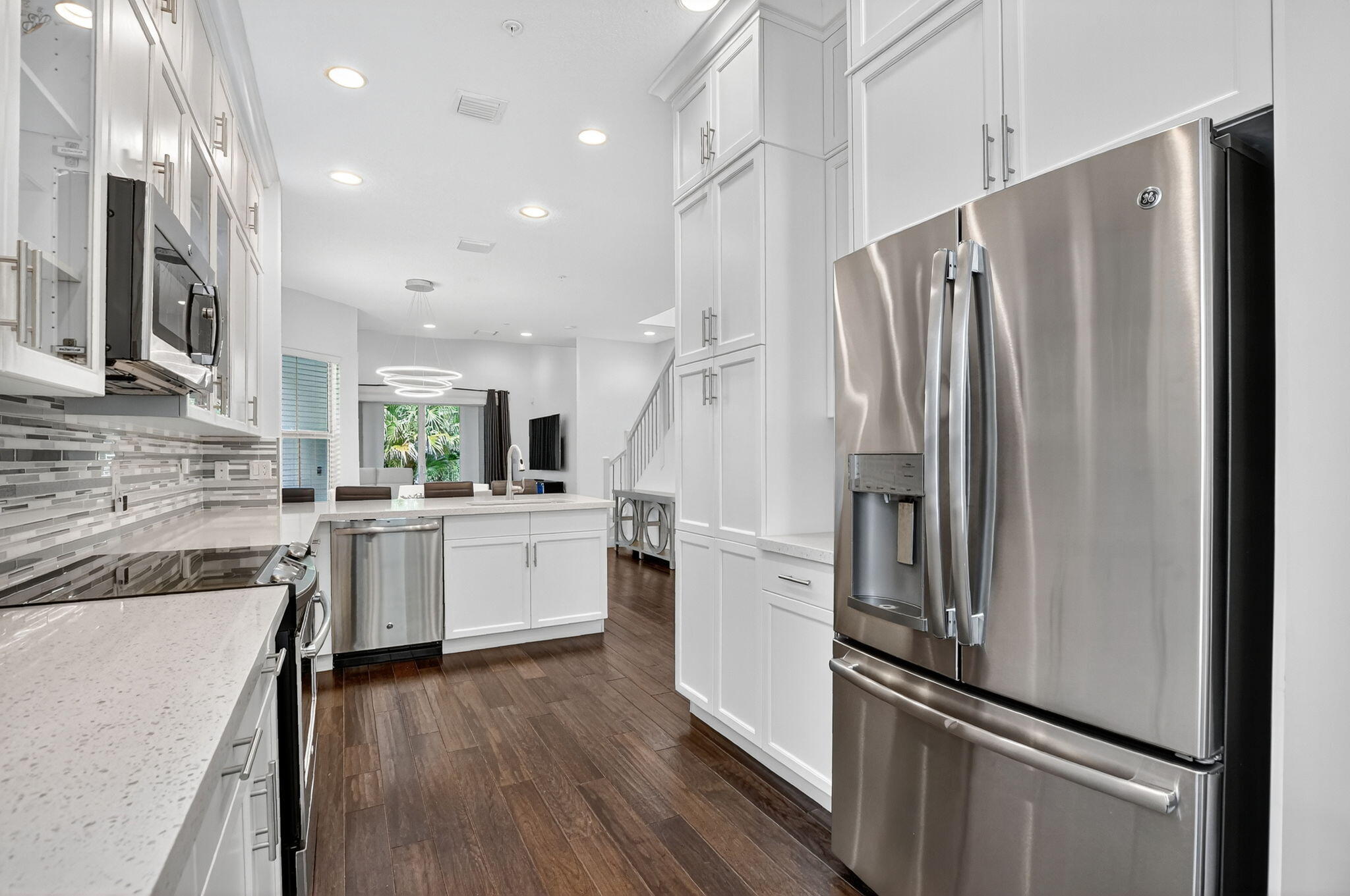 6675 Quiet Wave Trail Boca Raton, FL 33433 - Photo 16 of 65 a kitchen with white cabinets and stainless steel appliances