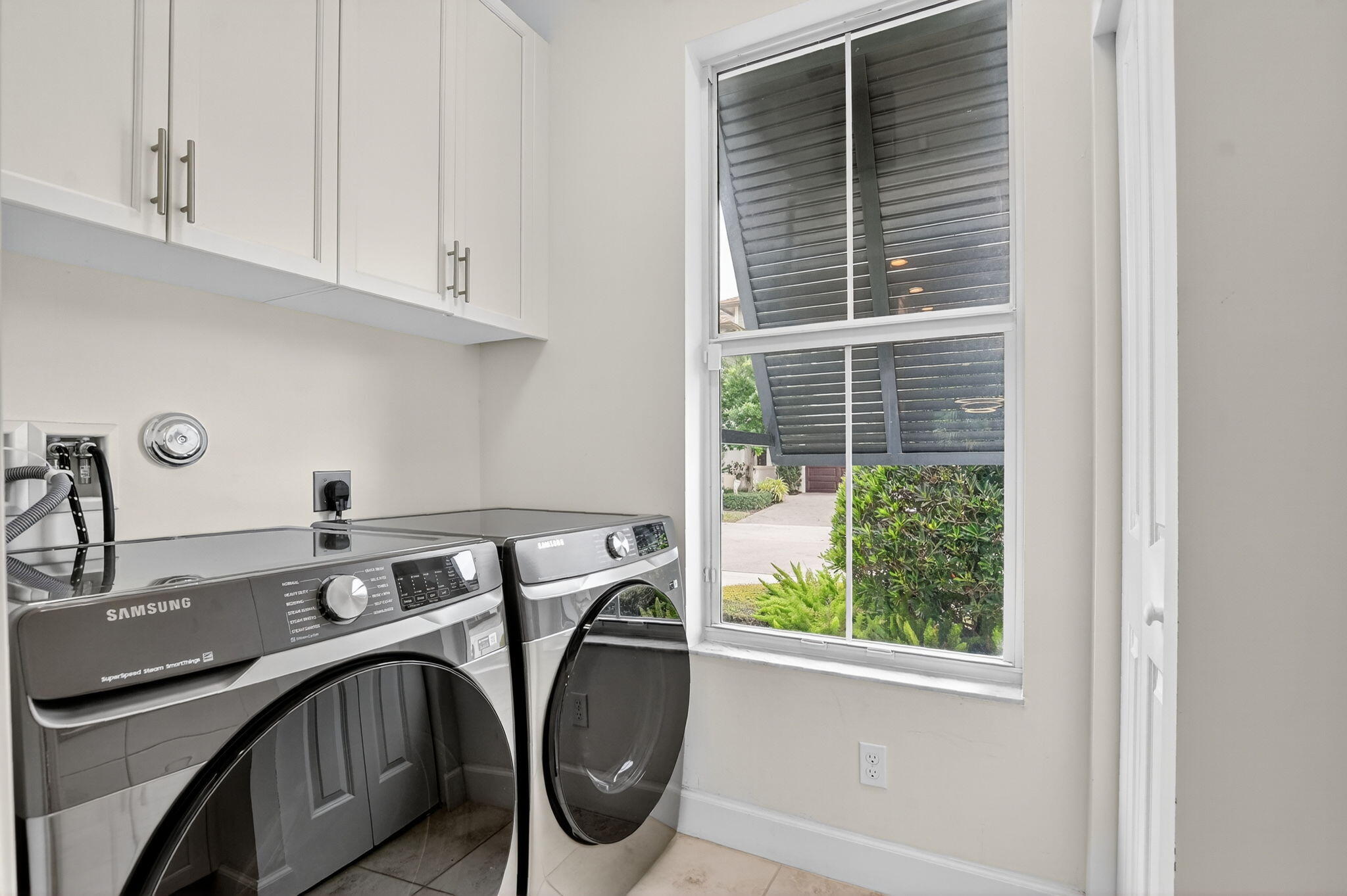 6675 Quiet Wave Trail Boca Raton, FL 33433 - Photo 18 of 65 a utility room with a window dryer and washer