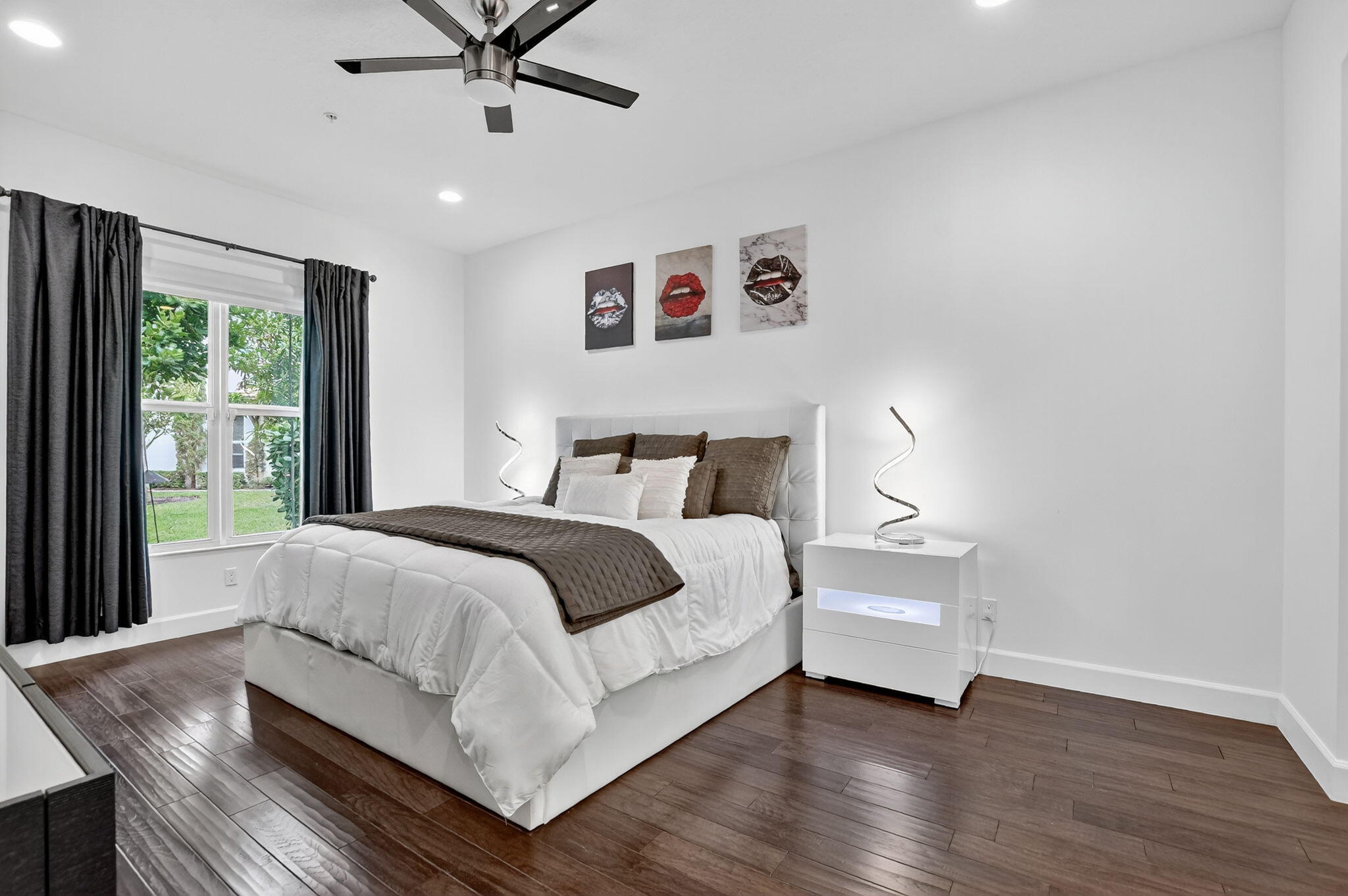 6675 Quiet Wave Trail Boca Raton, FL 33433 - Photo 24 of 65 a bedroom with a large bed and a large window