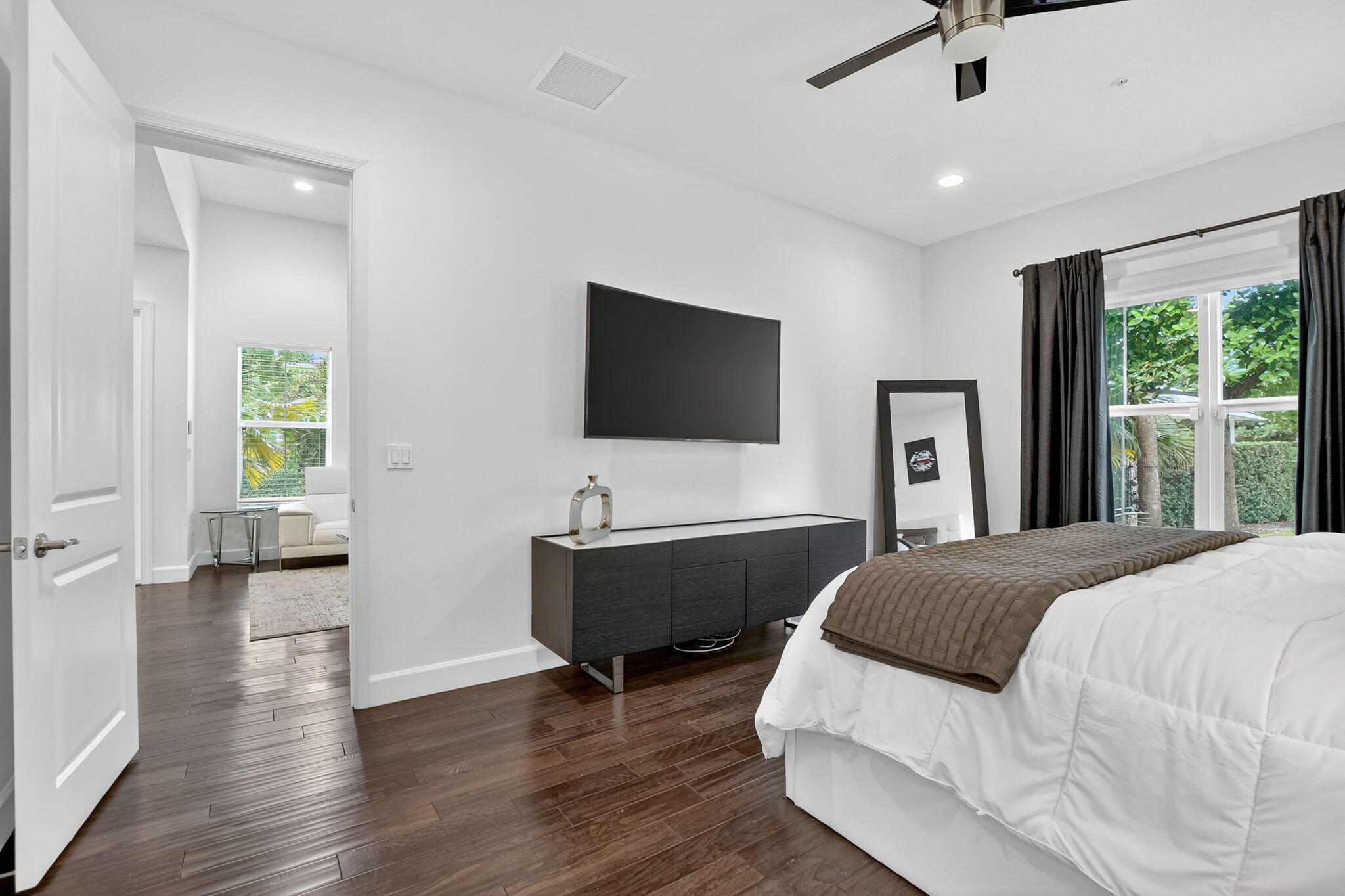 6675 Quiet Wave Trail Boca Raton, FL 33433 - Photo 25 of 65 a spacious bedroom with a bed and a flat tv screen on dresser