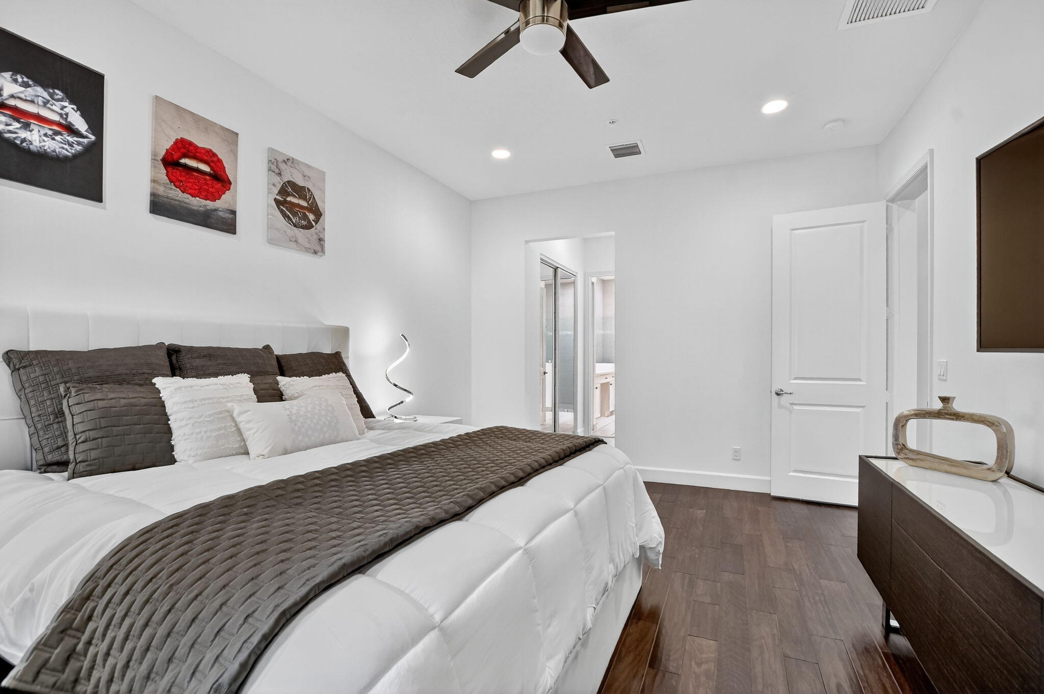 6675 Quiet Wave Trail Boca Raton, FL 33433 - Photo 26 of 65 a bedroom with a bed and a chandelier
