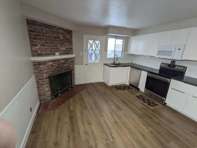 a kitchen with a stove a sink and a refrigerator