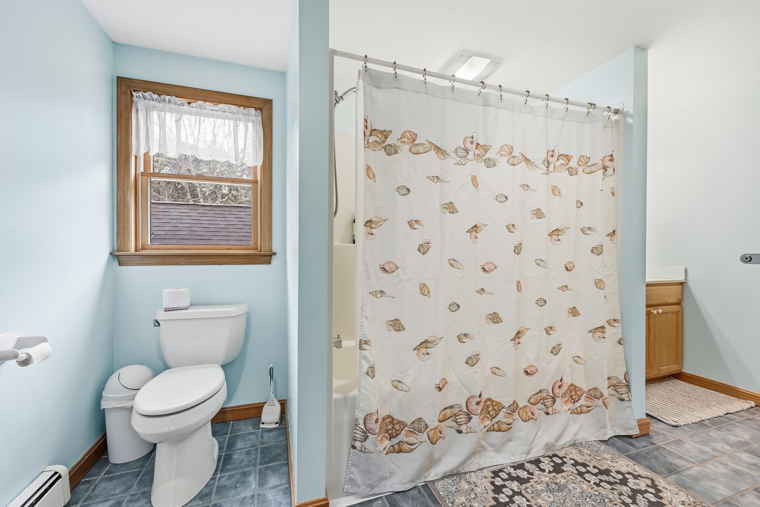 2 Short Lots Lane Truro, MA 02666 - Photo 33 of 61 a bathroom with a toilet and a shower curtain