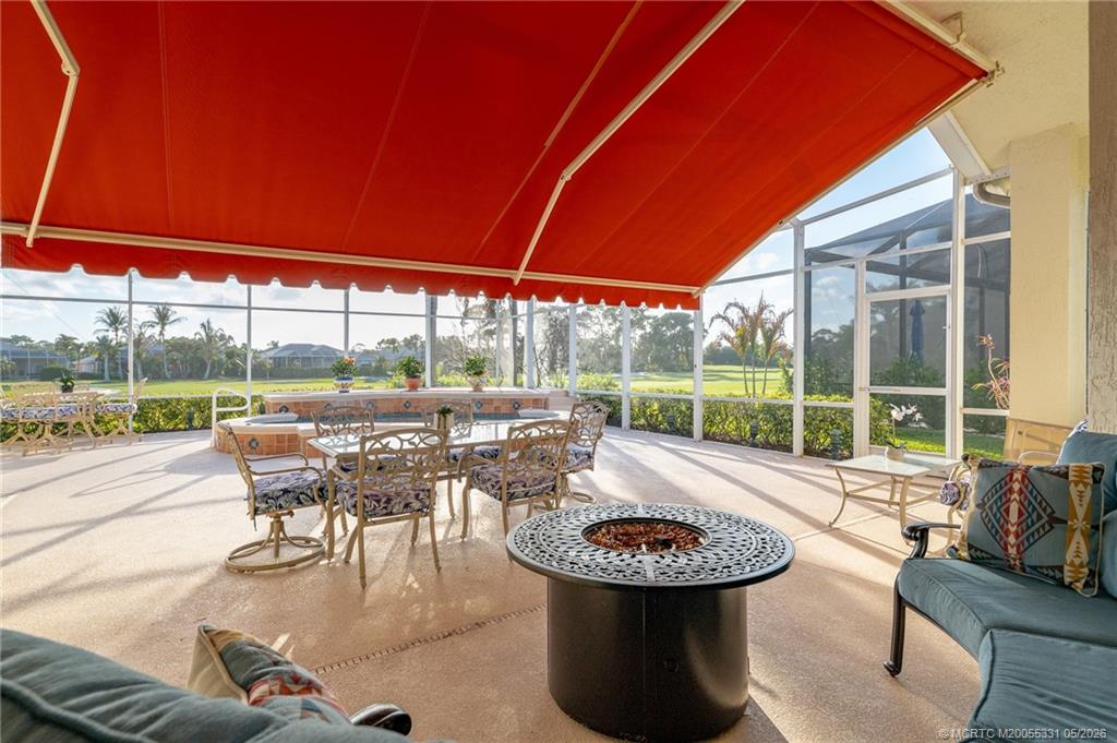 2216 Southeast Stonehaven Road Port St. Lucie, FL 34952 - Photo 27 of 67 a view of a patio with a table chairs and a small yard