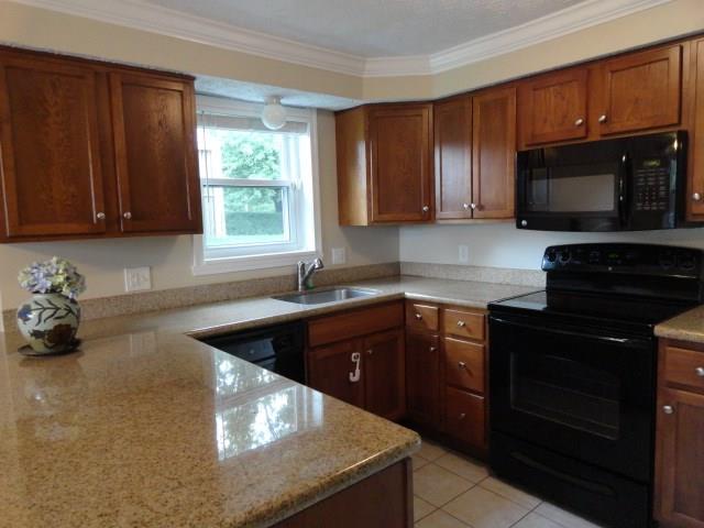 1506 Radford Road Pittsburgh, PA 15227 - Photo 8 of 24 Great Kitchen, Granite counter tops, Tile Flooring, tons of counter and storage space. Disposal, Dishwasher, Ele Stove, Microwave & Fridge all stay. Really Beautiful!